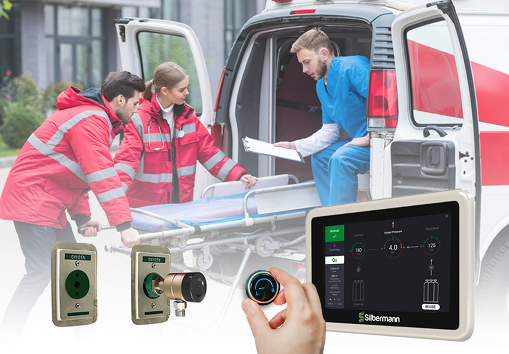 Paramedics standing beside an ambulance equipped with an oxygen delivery system featuring a manual changeover mechanism